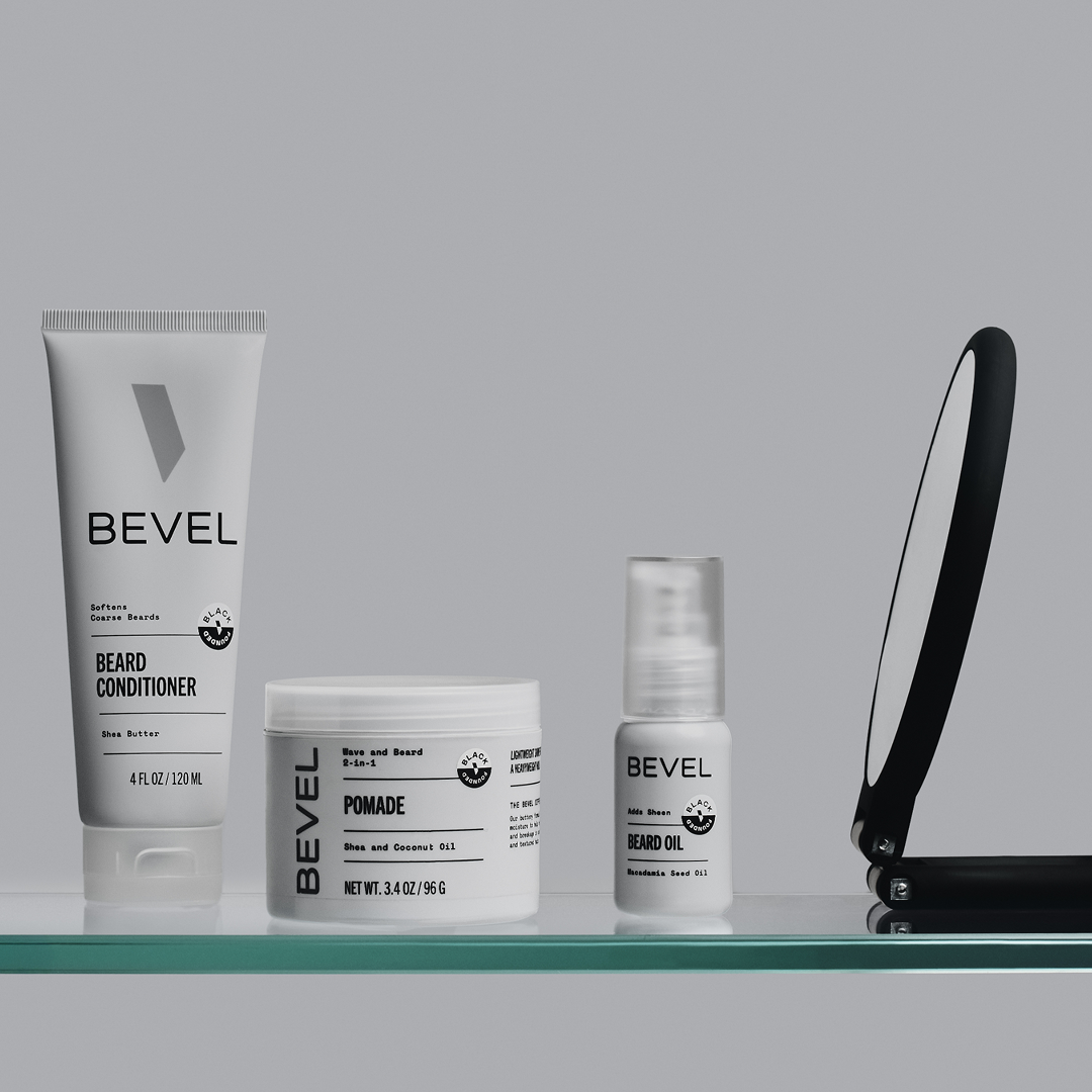 Bevel grooming products including a tube, jar, and spray bottle on a gray background