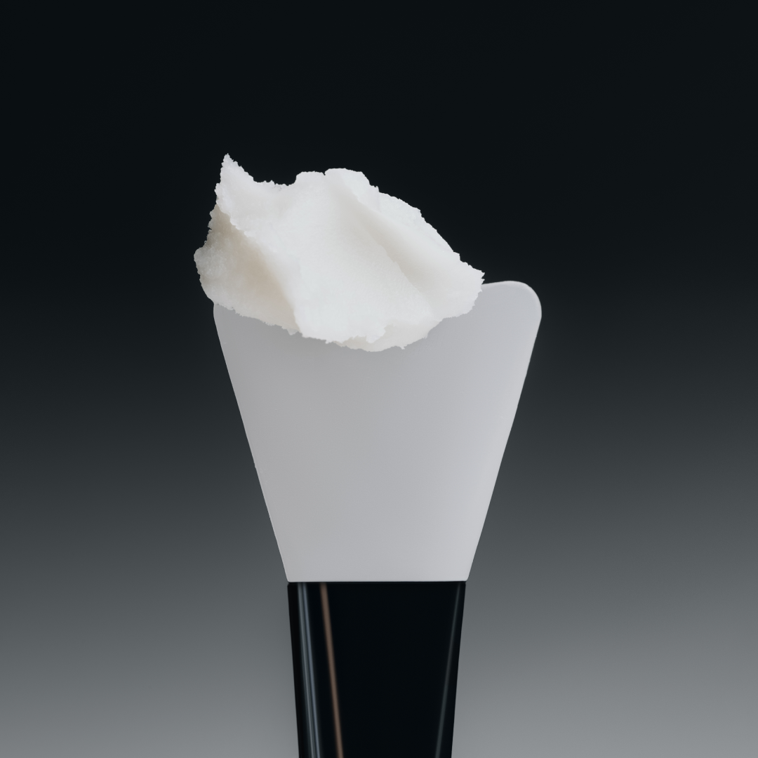 Makeup brush with white bristle head on a gradient black to gray background