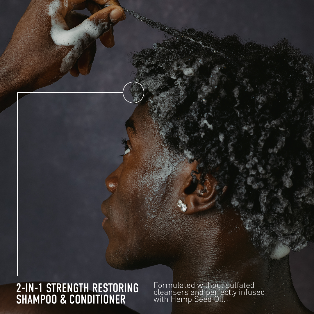 Person applying shampoo to their hair with a focus on product details, set against a dark background.