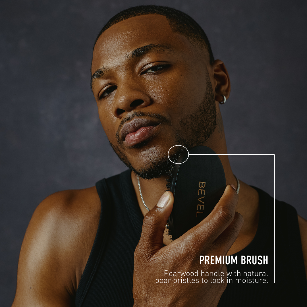 Man holding a BEVEL premium brush against a dark background