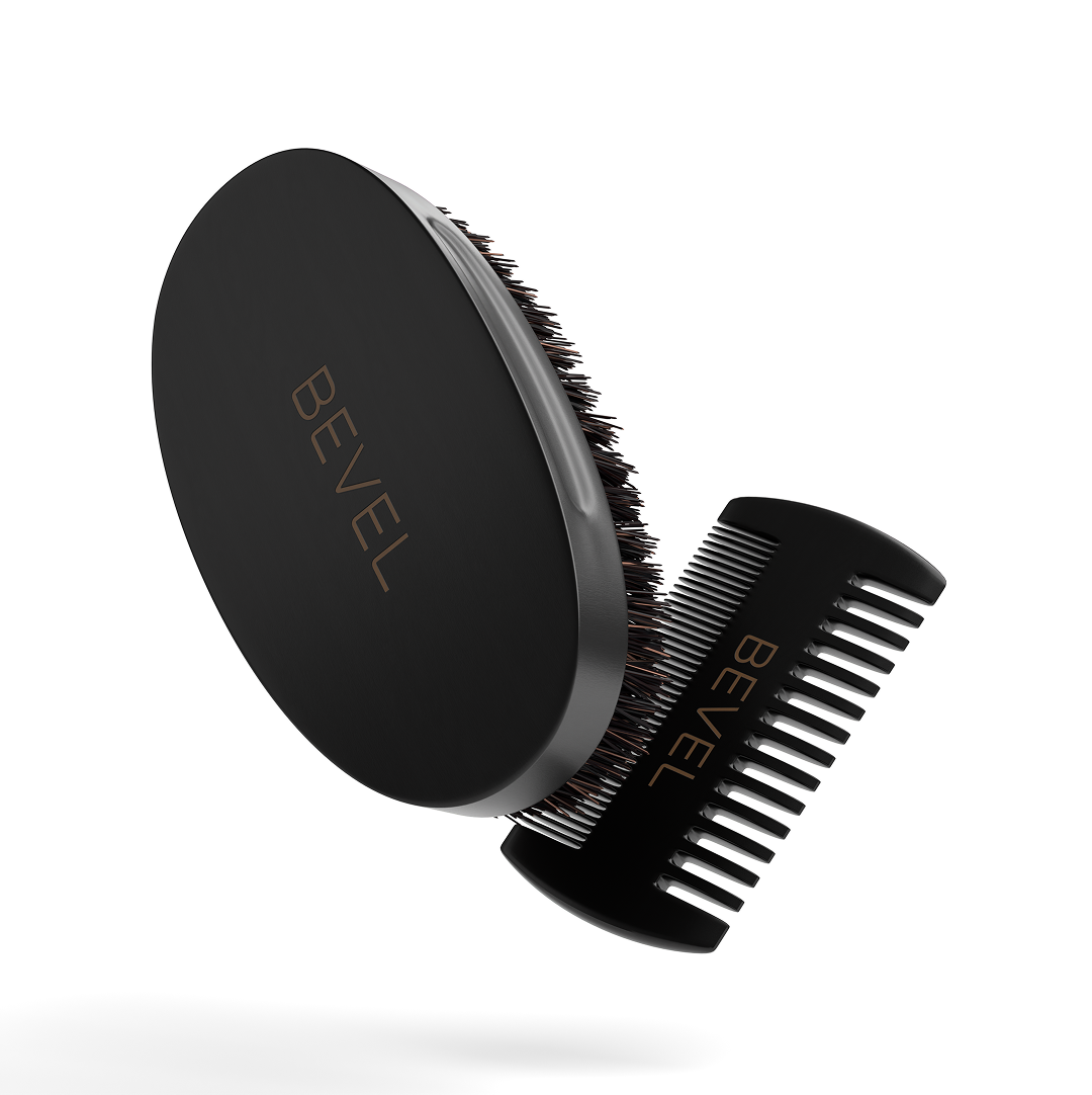 Black BEVEL grooming brush and comb on a white background