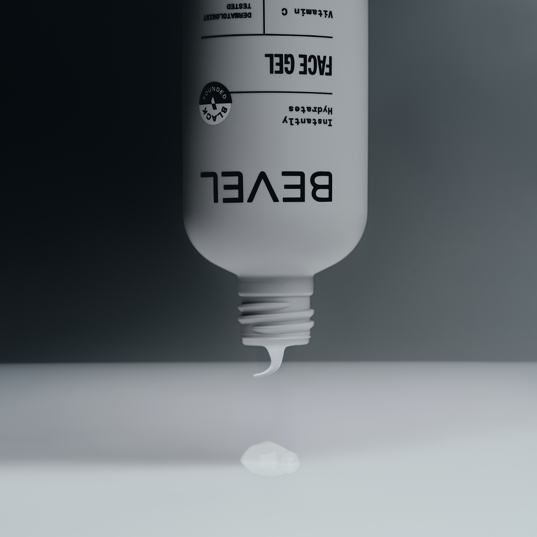 Bottle of BEVEL Face Gel with gel dripping onto a gray surface