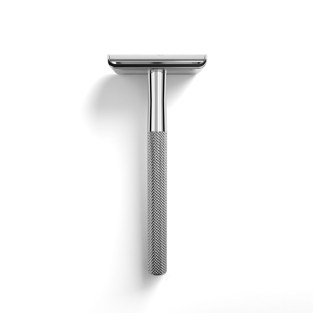 Silver safety razor on a white background