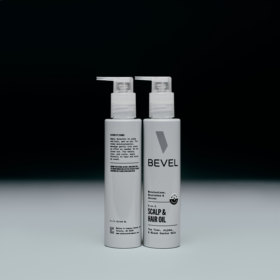 Two bottles of BEVEL scalp and hair oil on a gray background