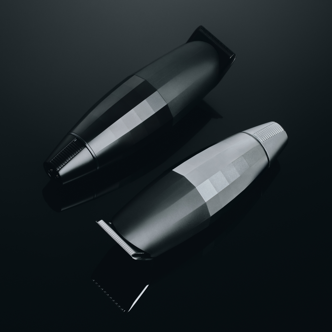 Two black and silver cylindrical objects on a reflective black surface